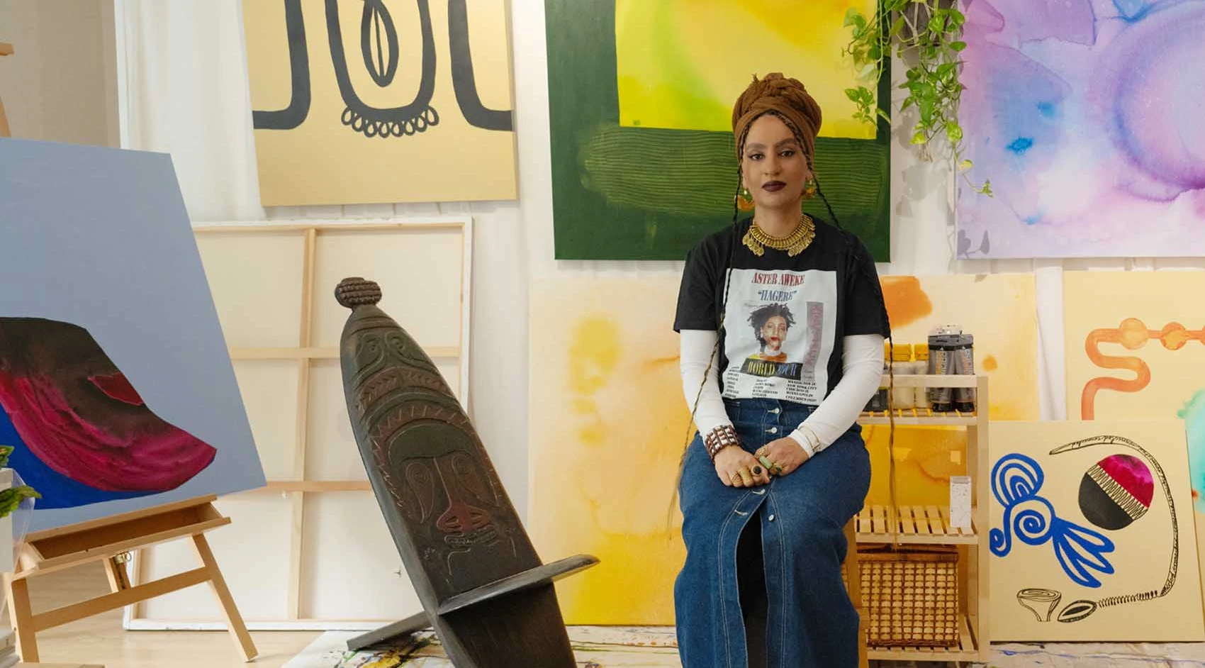 Artist Saba Tadele in her studio, surrounded by prints