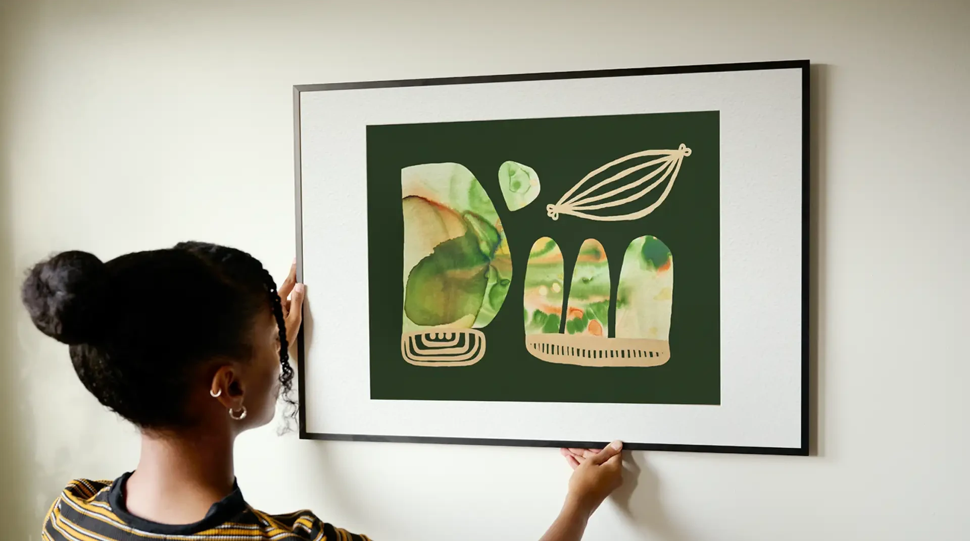 Framed abstract print being hung on a wall